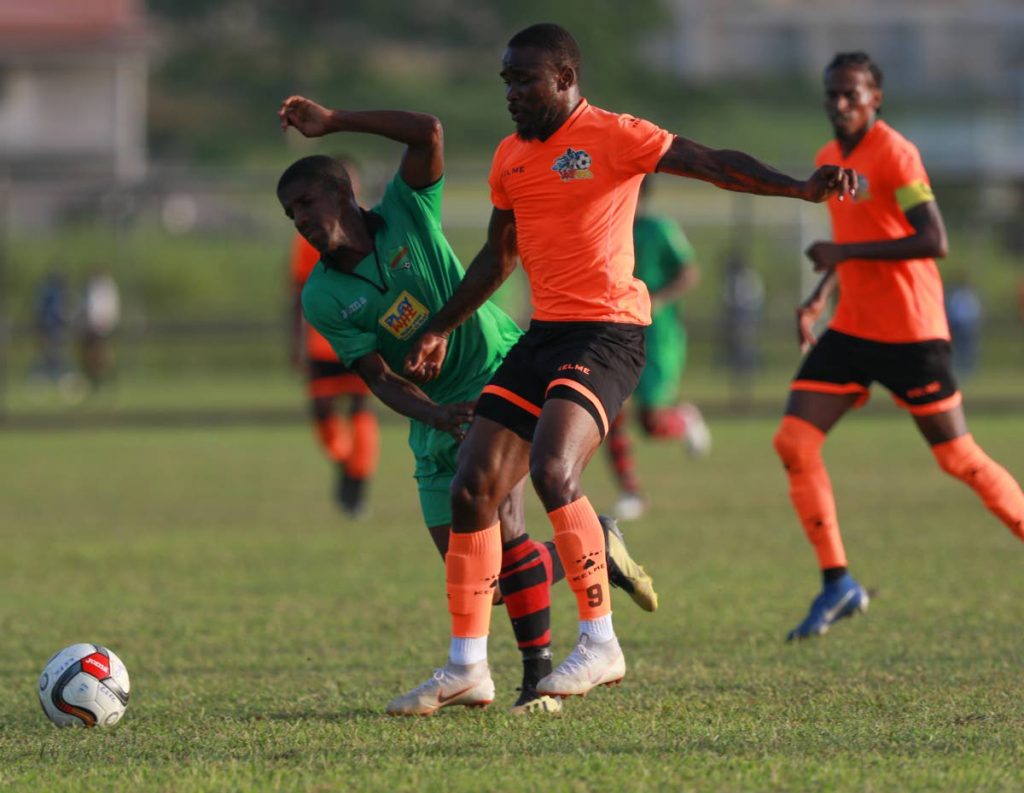 Club Sando FC’s Shackiel Henry,right, tries to gain control of the ball under pressure from San Juan Jabloteh’s Jameel Neptune try to close him down during the Ascension Invitational Match at the Mannie Ramjohn Stadium Training Ground, on Sunday.