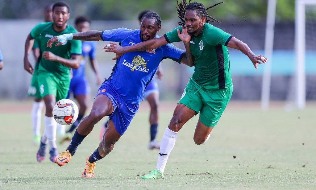 Nicholas Dillon, left, of Club Sando... The striker scored a hattrick in his team's 6-1 win over Metropolitan FA in the third-place match of the Concacaf Caribbean Shield in St Kitts and Nevis, yesterday. - Daniel Prentice