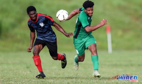 W Connection captain Caleb Boyce (right) tries to escape the attentions of Gasparillo Youths midfielder Daunte Julien during NLCL U19 Community Cup action at Plaisance Park on 22 January 2023. (Copyright Daniel Prentice/ Wired868)