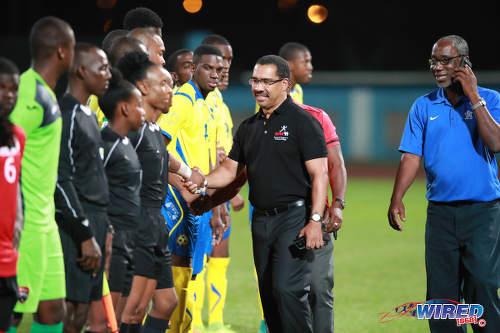 Photo: SPORTT CEO Adam Montserin (centre) greets players and officials before kick off between Trinidad and Tobago and Barbados at the Ato Boldon Stadium in Couva on 10 March 2017. TTFA vice-president Ewing Davis (right) broke away from the customary pre-game ritual to take a phone call. (Copyright CAI Images/Wired868)