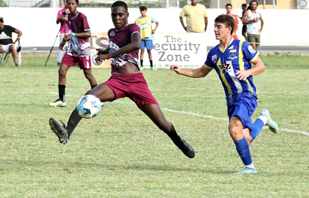 Fatima College’s Michael Chaves, right, challenges Bishop’s High School Johan Elliot for the ball during the Secondary Schools Football League Premiership Division match at Fatima Grounds, Mucurapo Road, Port-of-Spain, yesterday. ...ABRAHAM DIAZ