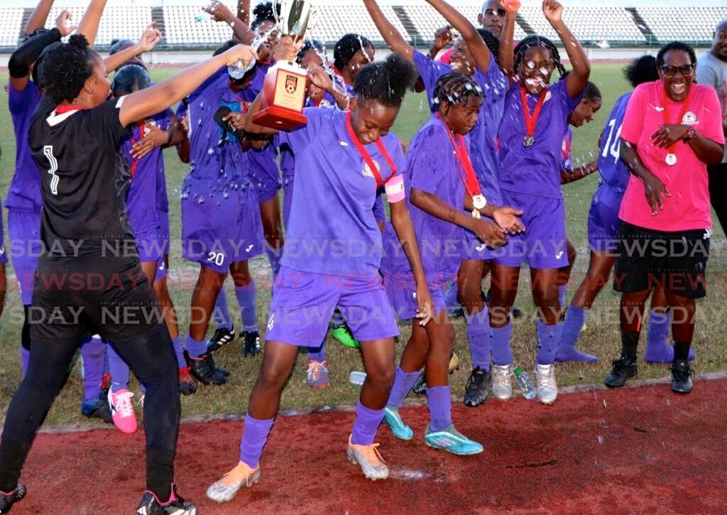 Five Rivers Secondary School footballers celebrate after winning their Coca-Cola Girls East Intercol final against San Juan North Secondary School, at the Larry Gomes Stadium on Monday. - Angelo Marcelle