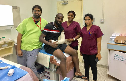 Photo: Trinidad and Tobago forward Cornell Glen (centre) poses with staff at the San Fernando General Hospital after breaking his arm in a Gold Cup qualifier against Haiti on 8 January 2017.