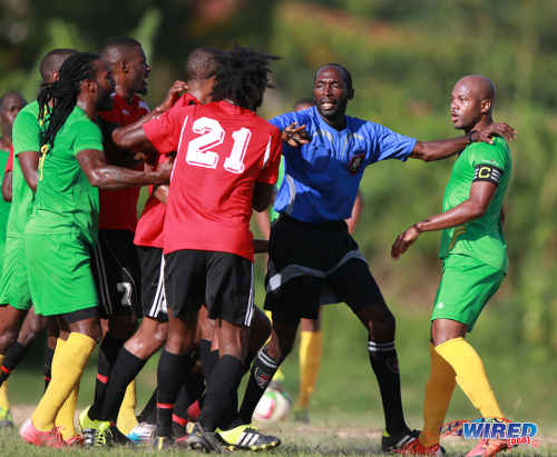 Photo: Referee Hasely Collette (centre) plays peacemaker while then Guaya United captain Ryan Stewart (right) assesses the situation during 2015/16 CNG NSL Premiership Division action at Matura. ...(Courtesy Nicholas Bhajan/Wired868)