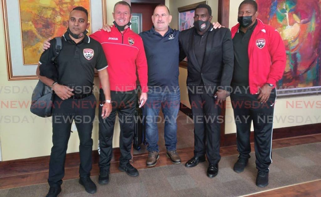 Normalisation committee chairman Robert Hadad, centre, with (left-right) TTFA media officer Shaun Fuentes, men's coach Terry Fenwick, manager Adrian Romain and assistant coach Derek King, at the Piarco International Airport on Thursday before the team left for the Dominican Republic. Photo by Joel Bailey-