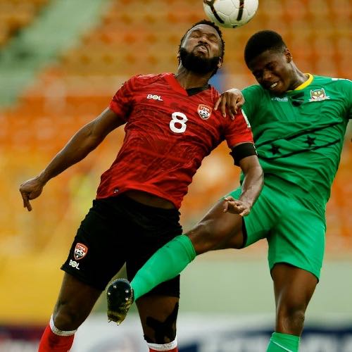 Photo: Trinidad and Tobago captain Khaleem Hyland (left) challenges St Kitts and Nevis defender Andre Burley in the air during 2022 World Cup qualifying action in Santo Domingo on 8 June 2021. (via TTFA Media)