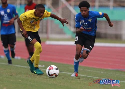 Photo: Presentation College (San F’do) winger Jordan Riley (right) tries to escape from St Benedict’s College defender Merlik Campbell during SSFL action in Marabella on 26 September 2018. (Copyright Nicholas Bhajan/CA-Images/Wired868)