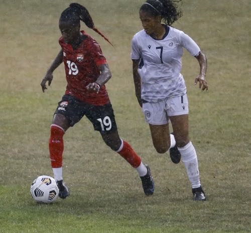 Photo: Trinidad and Tobago forward Kennya Cordner (left) tries to peel away from Dominican Republic midfielder Winibian Peralta during friendly international action in San Cristóbal on 30 November 2021. (via TTFA Media)