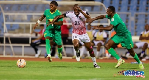 Trinidad and Tobago forward Kevon Woodley (centre) tries to burst clear of Guyana defenders Kevin Layne (right) and Nicholai Andrews during international friendly action at the Hasely Crawford Stadium in Port of Spain on 15 May 2024. Photo: Daniel Prentice/ Wired868
