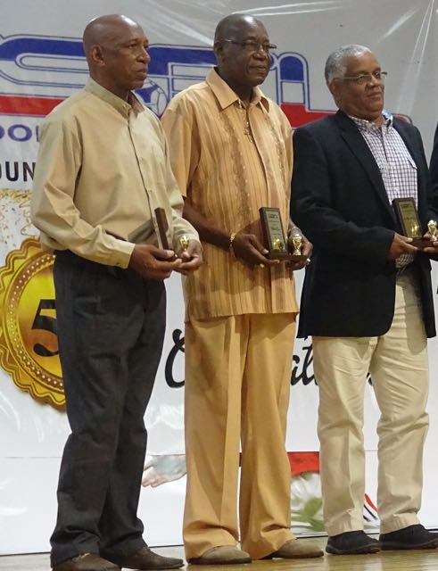 Photo above shows Leroy De Leon (left) and Wilfred Cave with Dr. Alvin Henderson, deputy chairman of the TTFA Technical Committee at the SSFL Awards Ceremony after receiving their awards on Saturday.