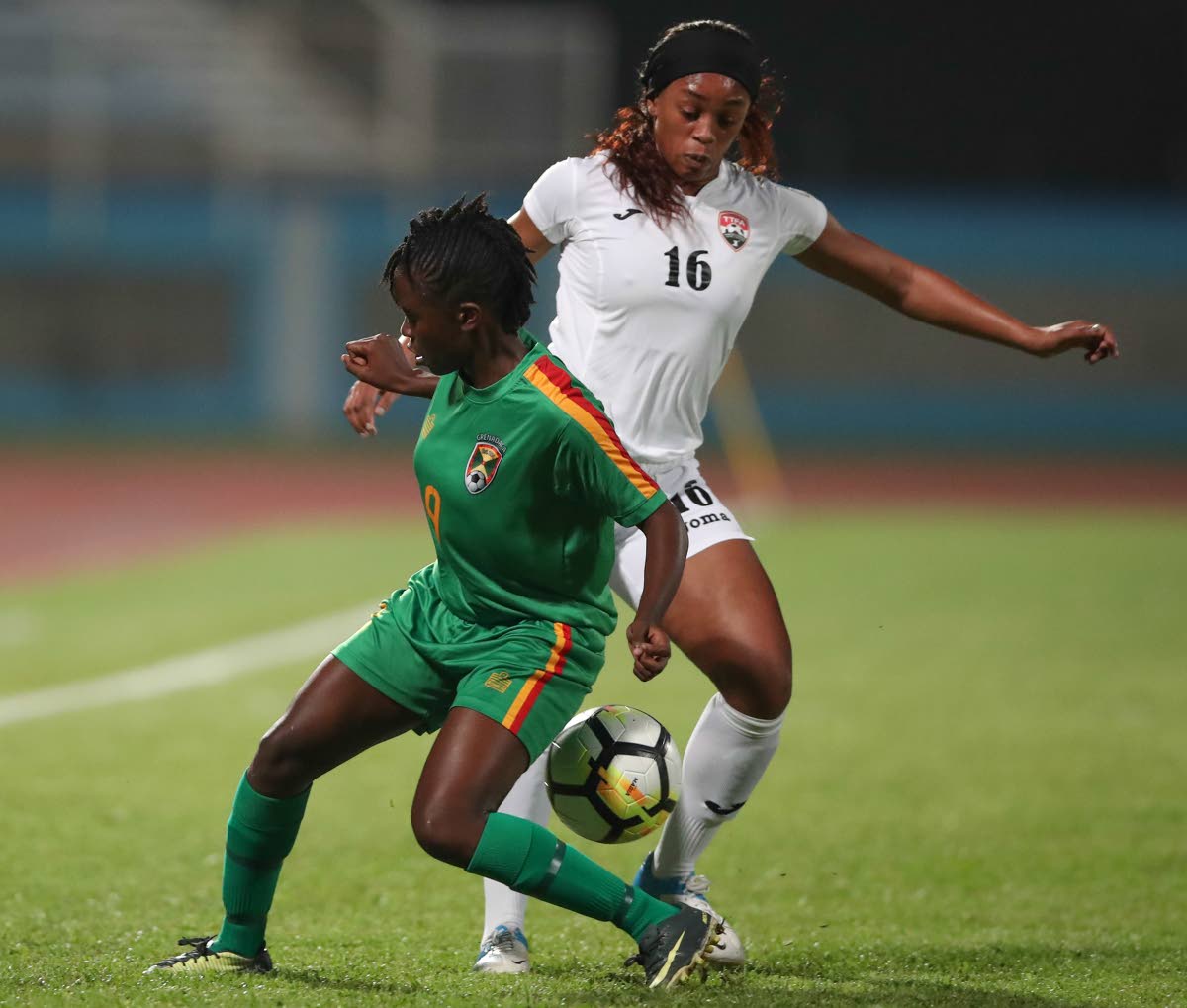 Trinidad and Tobago’s Linda Hinds, right, battles Grenada’s Sheranda Charles in the CFU Women’s Challenge Series 2018 at the Ato Boldon Stadium, Couva, recently.