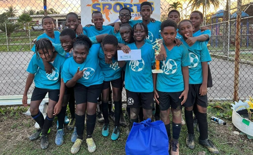 M12 Revolution players celebrate victory at last weekend's Seed of Greatness Biche Football Development School under-11 tournament. -