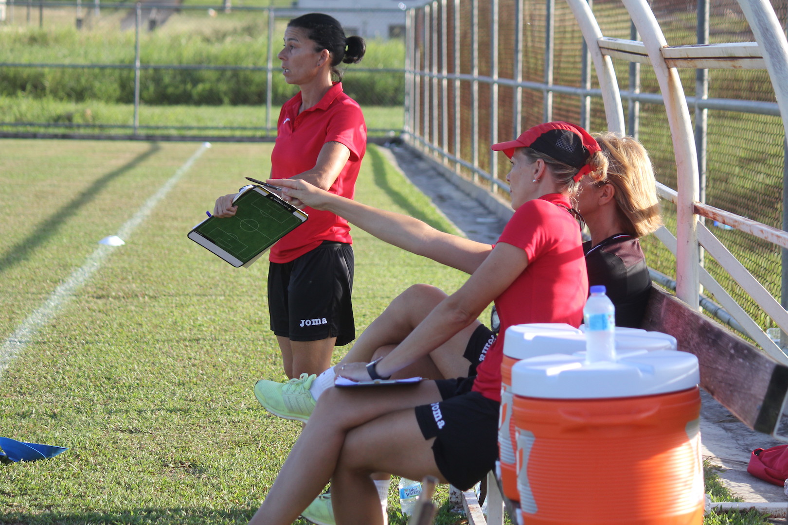 Nicola Williams points out an observation to Carolina Morace and Manuela Tesse during U-17 trials on Saturday.