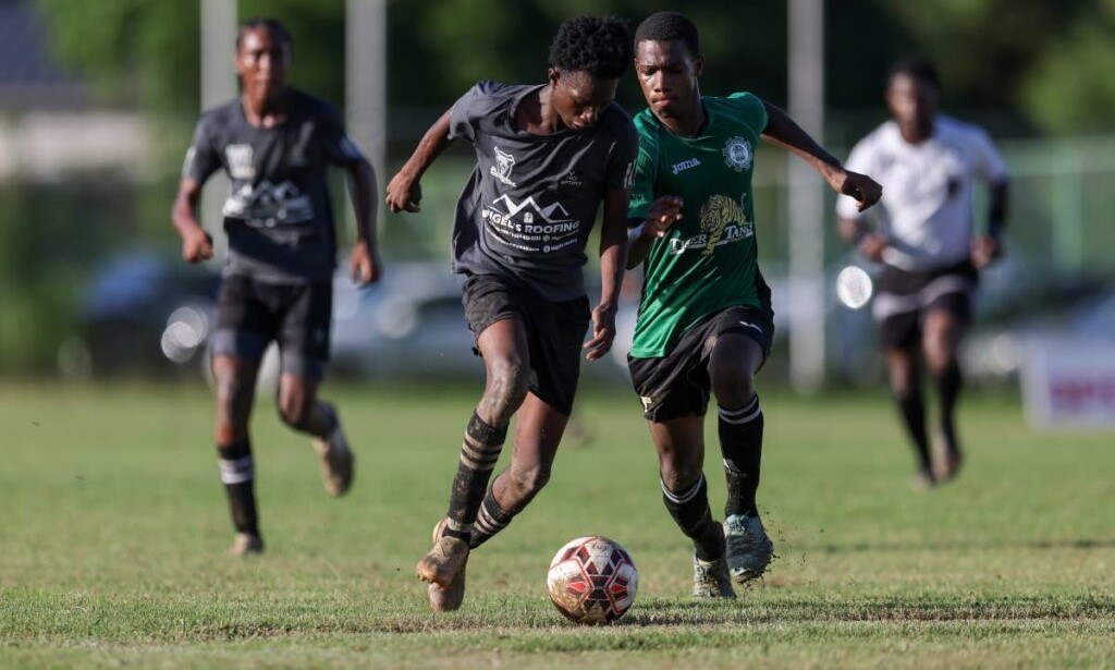 Miracle Ministries’ Kyle Holder (L) gets past Carapichaima East Rayhan Roberts during the SSFL Central Zone Intercol semifinal match at Edinburgh 500 ground on Tuesday, November 14th 2023 in Chaguanas. PHOTO BY: Daniel Prentice