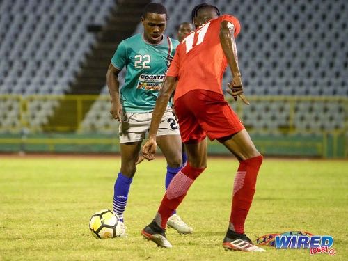 Photo: Morvant Caledonia flanker Joshua Alexander (left) runs at TLH Rangers defender Ross Russell Jr during Pro League action at the Hasely Crawford Stadium on 21 January 2020. (Copyright Daniel Prentice/CA-Images/Wired868)