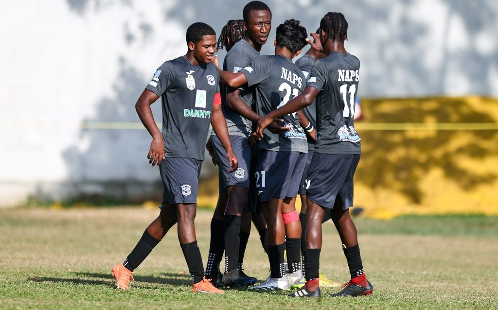 Naparima College defender Jaron Pascall, centre, celebrates with his teammates after scoring against St Mary’s College during the Secondary School Football League match at the CIC Grounds in St Clair, Port-of-Spain, yesterday. Naparima College won 3-2. (Photo by Daniel Prentice).