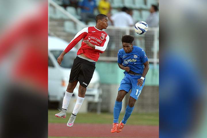 AERIAL BATTLE: St Anthony’s Nkosi Salandy, left, heads the ball over Naparima College’s Jarred Dass during the Secondary Schools Football League Coca Cola National InterCol final at the Manny Ramjohn Stadium, Marabella, yesterday. Dass scored twice as Naparima won 2-0. –Photo: DEXTER PHILIP