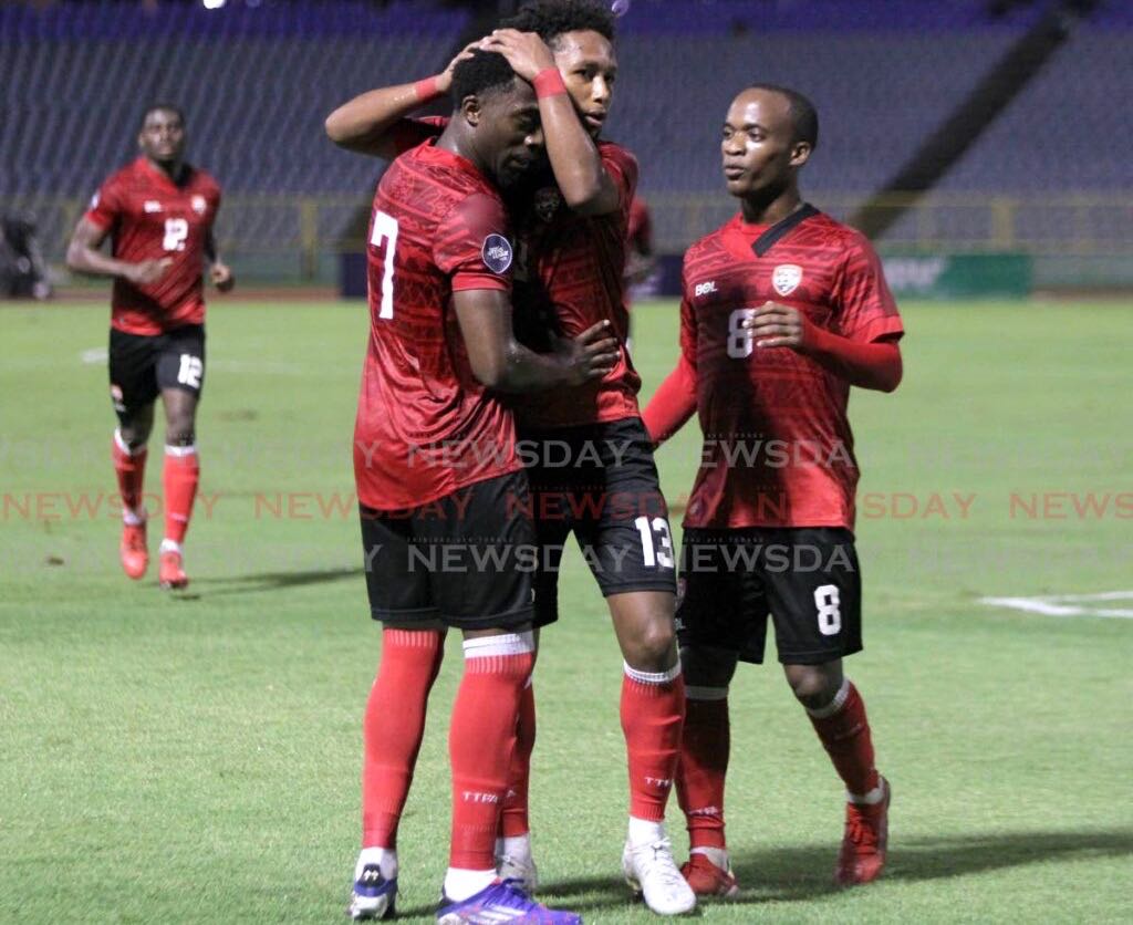 TT's Judah Garcia, centre, congratulates teammate Noah Powder, left, after he scored against St Vincent and the Grenadines during the Concacaf Nations League match, on Monday, at Hasely Crawford Stadium, Port of Spain. - Photo by Roger Jacob