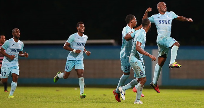 Photo: Police FC players including Kareem Freitas, second from left, and Elijah Belgrave, airborne, celebrate a goal during the 2016-17 Pro League season.