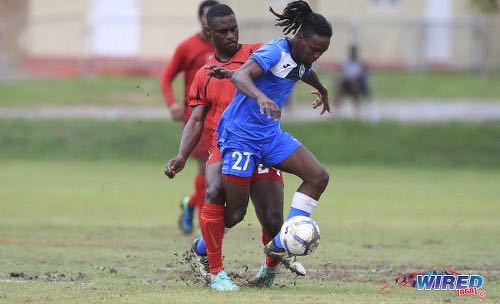 Photo: Police FC right back Kaydion Gabriel (right) tries to escape from Matura ReUnited midfielder Russel Alfred during Ascension Invitational action at the Police Academy in St James on 3 August 2019. Gabriel usually represents Central FC in the Pro League competition. (Copyright Allan V Crane/CA-images/Wired868)