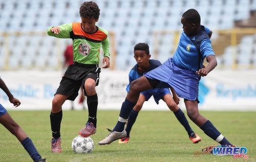 Photo: T&T Maestros midfielder Ocean Lindsay (centre) tries to pirouette past a FC Santa Rosa opponent during the RBNYL Under-13 final at the Hasely Crawford Stadium on 1 July 2017. (Courtesy Allan V Crane/CA-Images/Wired868)