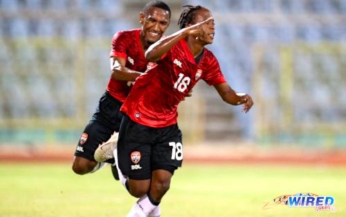 Teenager Real Gill (right) celebrates his maiden goal for the Trinidad and Tobago Men’s National Senior Team with fellow substitute John-Paul Rochford at the Hasely Crawford Stadium on 29 January 2023. T&T downed Saint Martin 2-0 in a friendly affair. (Copyright Daniel Prentice/ Wired868)