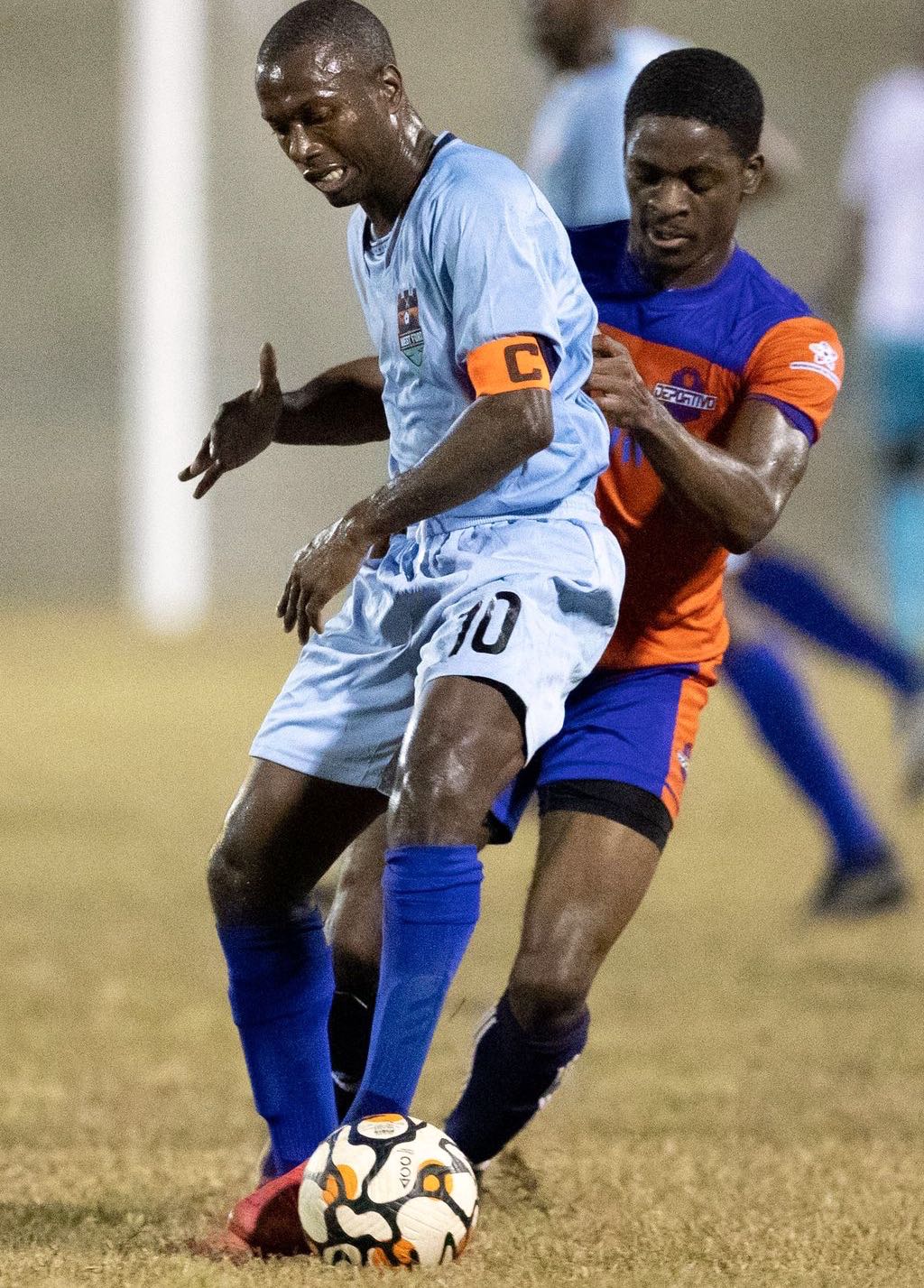 Real West Fort midfielder Keron Cummings, left, screens off the ball from Deportivo PF's defender Justin Cornwall during the Ascension Football Tournament at the Arima Velodrome on Saturday. Deportivo PF won 4-0. (Photo by Daniel Prentice)