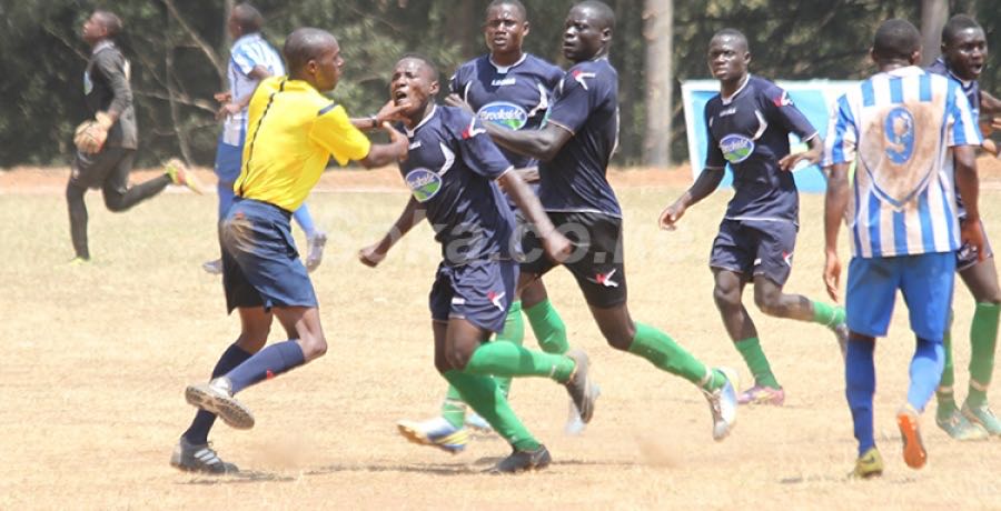 Referee being beaten up by St. Mary's Kitende players after losing to Alliance
