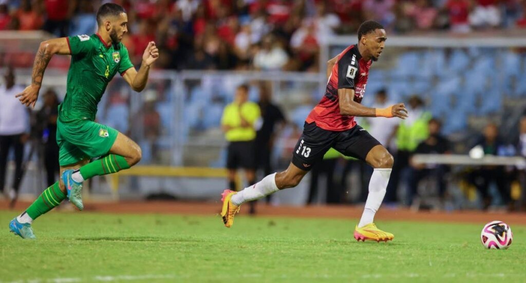 T&T's Reon Moore runs with ball during the World Cup qualifier against Grenada on June 5, 2024, at the Hasely Crawford Stadium, Port of Spain. - Daniel Prentice