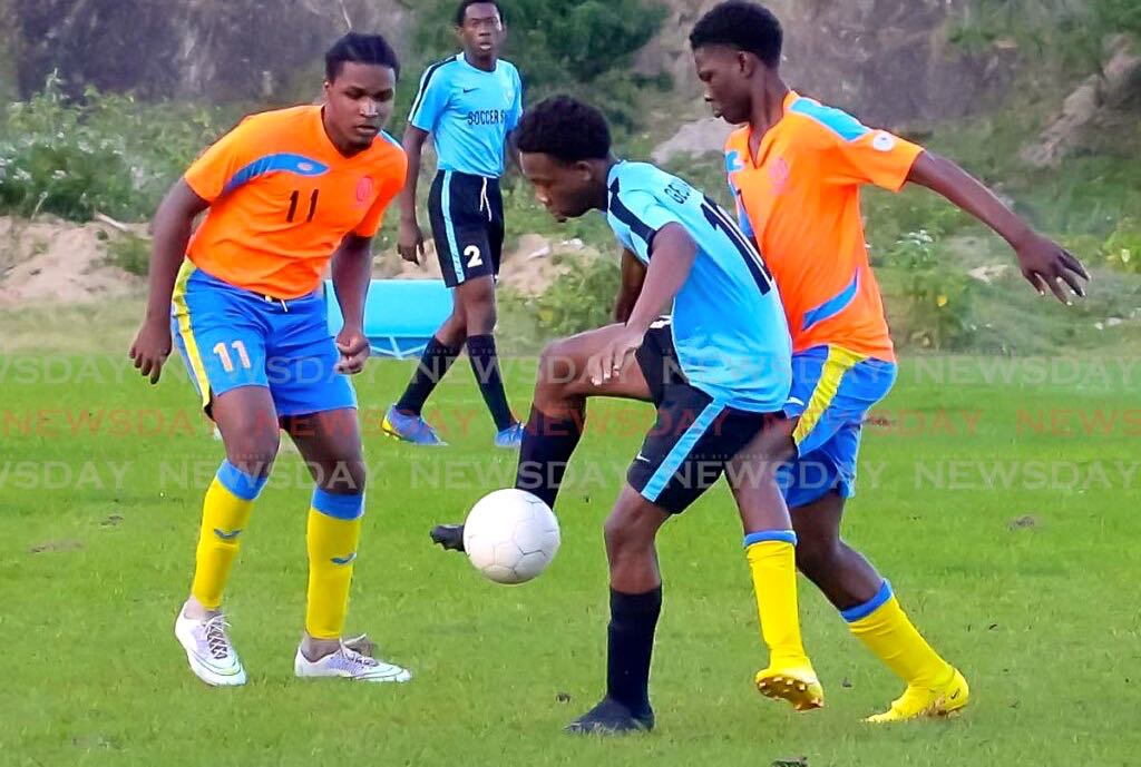 In this January 12 photo, Jaheim Roberts of Georgia FC, centre, controls the ball under pressure from two Roxborough Lakers players in the NLCL U-19 Community Cup match at Moriah Recreation Ground. - David Reid