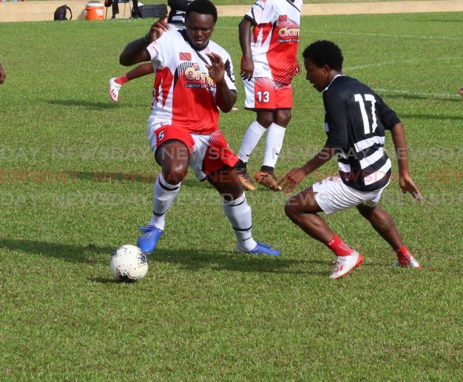 T&T footballer Sean Bonval, right, puts pressure on Jahiem Harry of the Tobago XI in a TT practice match at the St James Police Barracks in St James, on Saturday. PHOTO BY SUREASH CHOLAI - Sureash Cholai