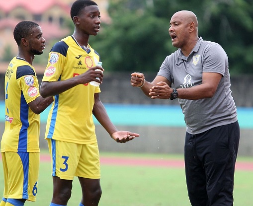 Shawn Cooper, right, the head coach of Presentation College of San Fernando gives instruction to his players Luke Charles, centre, and Zion Allen during their SSFL Premiership Division match at the Ato Boldon Stadium in Balmain, Couva on October 9. Presentation won 1-0. ...ANTHONY HARRIS
