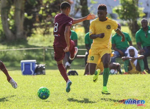 Photo: Signal Hill Secondary captain Akil Frank (right) slips the ball past East Mucurapo player Joshua Constantine during SSFL Premier Division action at Moka on 14 September 2016. ...(Courtesy Sean Morrison/Wired868)