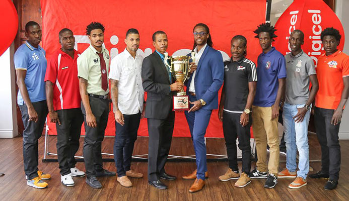​​Photo: Christopher Edmond, Senior Sponsorship Officer at Digicel (Trinidad and Tobago Limited), left of trophy, and Dexter Skeene, TT Pro League CEO, take centre stage with players during the launch of the Digicel Pro Bowl 2016/17 season edition at the VIP Lounge of the Hasely Crawford Stadium on Feb. 1, 2017.