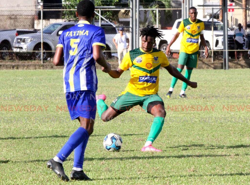 St Benedict’s College player Josiah Ochoa (C) looks to kick the ball during the Secondary Schools Football League Premiership Division match, on Wednesday, at Fatima Grounds, Mucurapo. The match ended 0-0. - Ayanna Kinsale