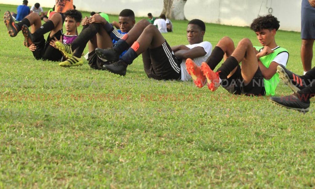 Members of the St Mary’s College Under16 football team go through some exercises during the team’s first training session since an ease on covid19 safety restrictions, at the CIC Grounds, St Clair, on Monday. - Ayanna Kinsale