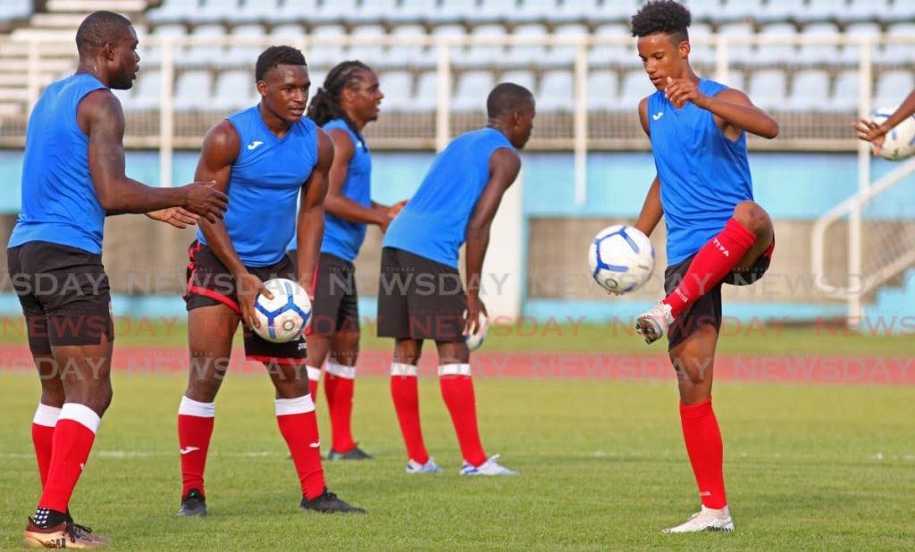 Gary Griffith III, right, takes part in a T&T senior men’s team football training session, at the Ato Boldon Stadium, Couva, on Tuesday. T&T are due to play a friendly against the US on January 31. - Marvin Hamilton