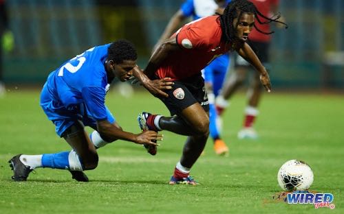 Photo: Trinidad and Tobago midfielder Molik Khan (right) turns away from Police FC midfielder Raheem Jawahir during a practice match at the Hasely Crawford Stadium on 12 March 2021. Khan, 16, is the youngest member of the current Soca Warriors team. (Copyright Daniel Prentice/Wired868)