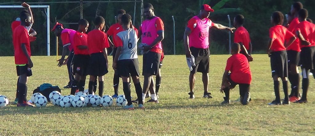 Stuart Charles-Fevrier talks to a few of his players at training on Thursday at the TTFA Home of Football in Couva/TTFA Media.