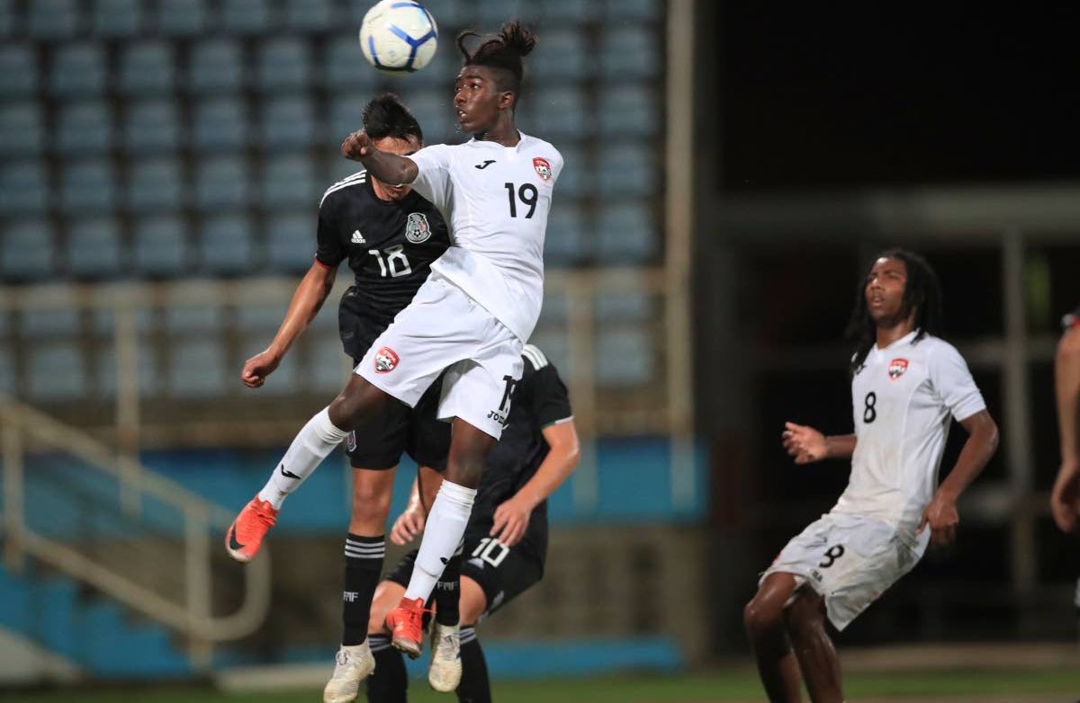 T&T’s Isaiah Thompson (#19) attempts to steer a header towards goal, during day 3 match 2, of the TTFA Youth Invitational Tournament between TT and Mexico, at the Ato Boldon Stadium, Couva,on Sunday. Mexico won 4-1.