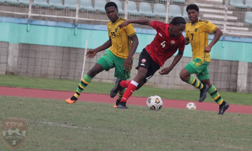 A T&T Under-15 players dribbles past Jamaica during a practice match, on Sunday, at the Manny Ramjohn Stadium, Marabella. - TTFA Media