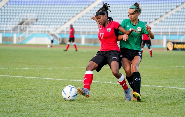 T&T’s Aaliyah Prince, left, on the ball against St Kitts and Nevis in the Concacaf Women’s Olympic Zone Qualifiers, at the Ato Boldon Stadium, Couva,on Sunday. PHOTO BY DANIEL PRENTICE/CA-images