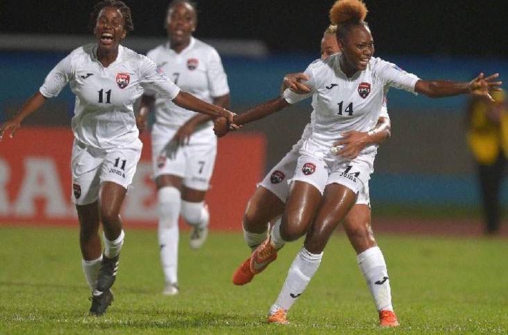 CELEBRATION TIME: Trinidad and Tobago U-20 women celebrate Kedie Johnson’s (#14 ) goal from a corner-kick which provided T&T with a two-goal cushion against Haiti on Thursday night at Ato Boldon Stadium, Couva. Teammates Renae Ward, left, Dennecia Prince, second left, and Shenieka Paul (partially hidden) join in the celebrations. However, Haiti rallied for a come-from-behind 3-2 victory in the U-20 Women CONCACAF Championship contest. --Photo: DEXTER PHILIP