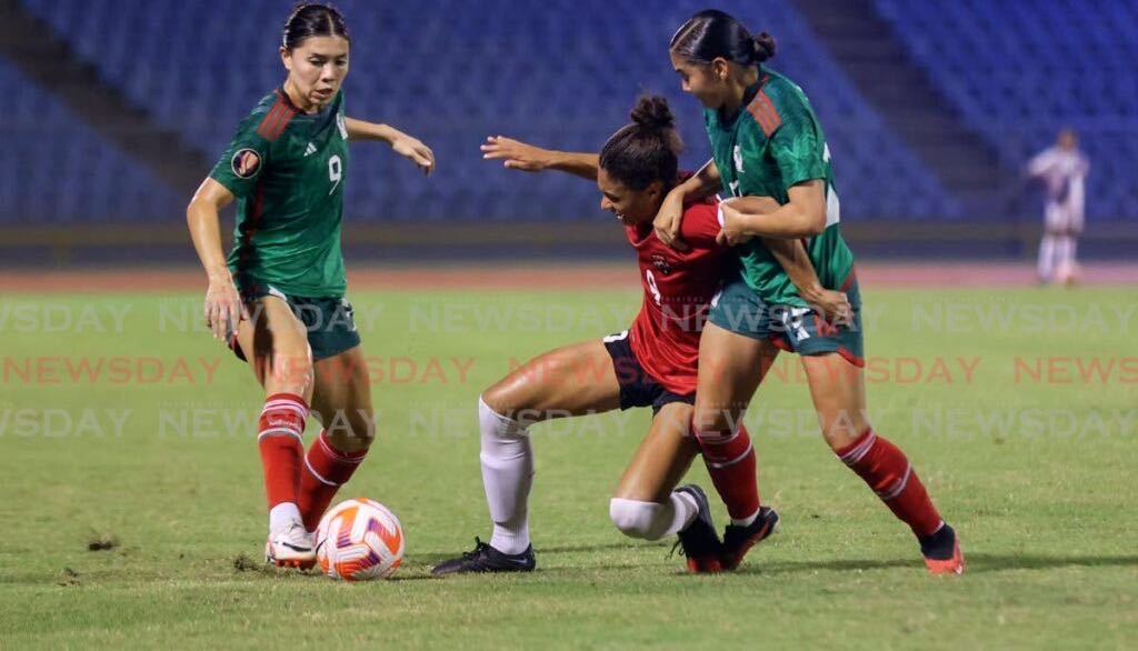 T&T Zoe Maxwell, centre, battle for possession against Mexico’s Kiana Palacios, left, and Nicole Perez during the Concacaf Women's Gold Cup qualifier at the Hasely Crawford Stadium, Mucurapo on Tuesday. - Photo by Daniel Prentice