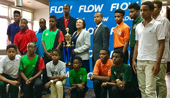 Cindy-Ann Gatt, Director of Marketing at Flow (with trophy), is flanked by Trinidad and Tobago Men's Senior Team head coach Dennis Lawrence (L) and TT Pro League CEO Dexter Skeene, along with Flow Youth Pro League players during the launch of the 2017 Flow YPL at the VIP Lounge of the Hasely Crawford Stadium on 3 March 2017.
