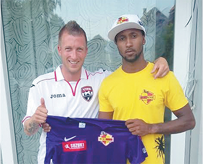 FLASHBACK PHOTO - National beach soccer goalkeeper, Zane Coker, right, is presented with his playing kit by president and coach BSC Bienne Hatchets, Sascha Feuz, in Switzerland on Thursday when the 25-year-old was unveiled to fans. Coker helped the club’s reserve team to two wins in his maiden appearances, Saturday.