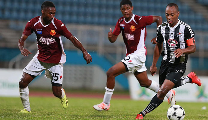 Central FC captain and midfielder Leston Paul, right, during FridayÂ’s 2014 First Citizens Cup Final at the Ato Boldon Stadium. Keeping close chase are North East Stars defender Keryn Navarro, #25, and substitute Taryk Sampson. (ttproleague).