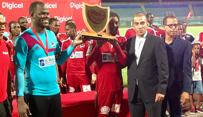 Photo: Central FC goalkeeper and captain Jan-Michael Williams, left, and veteran midfielder Marvin Oliver take centre stage to receive the 2015 Digicel Charity Shield from aspiring FIFA president David Nakhid, third from left, and TT Pro League CEO Dexter Skeene. Central edged rivals W Connection 1-0 at the Ato Boldon Stadium in Couva on 11 September to take the title.
