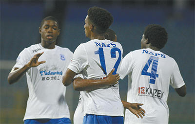 Naparima College striker Jarred Dass (#12) is congratulated by team-mates from right, Stephon Smith and Nicholas Thomas after scoring his team’s opening goal versus Queen’s Royal College in their Secondary Schools Football League Premier Division encounter at the Hasely Crawford Stadium, Mucurapo on Wednesday night. Naparima won 2-0. Photo: Anthony Harris