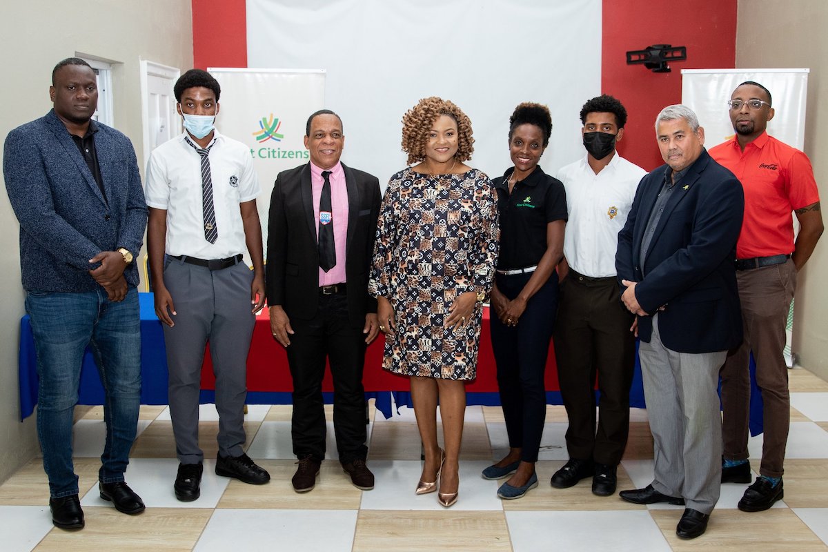 ALL TOGETHER: Education Minister Dr Nyan Gadsby-Dolly, centre, is flanked by stakeholders of the Secondary Schools Football League officials, including SSFL president Merere Louis Gonzales, third from left, representatives of sponsors First Citizens, the Ascension Tournament, Tiger Tanks Limited and Coca Cola, along with two young footballers who will participate in the 2022 season which begins tomorrow